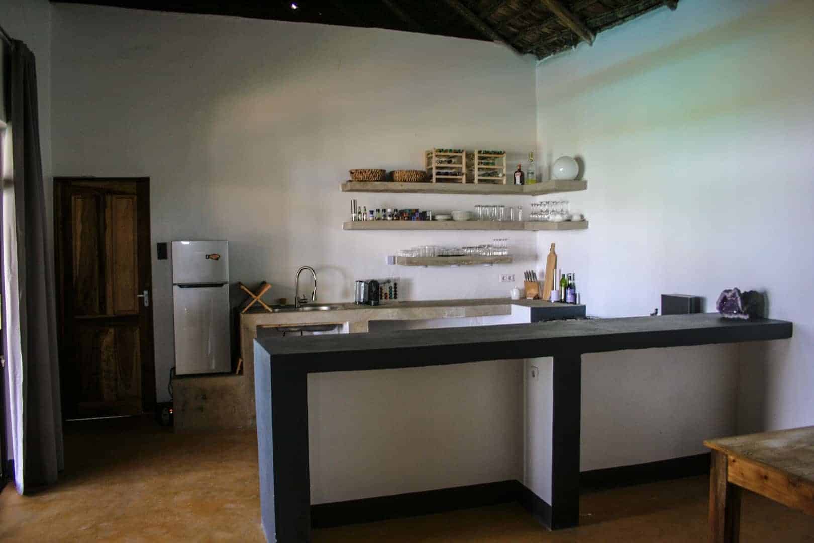 Kitchen with refrigerator and bar
